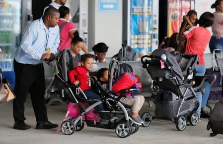 Young passengers are aided after disembarking the Bahamas Paradise Cruise Line ship, Grand Celebration, in Riviera Beach