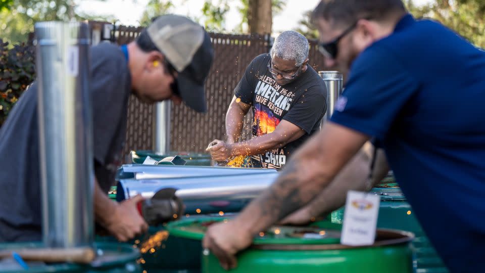 International Aerospace Machinists member Clint Moore, center, builds burn barrels with fellow union members in preparation for a strike if members reject a contract offer by airplane maker Boeing on September 12, 2024, in Seattle, Washington. - Stephen Brashear/AP