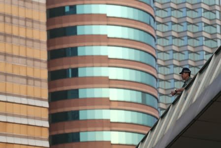 A police officer stands guard ahead of a planned black balloon protest at Tsim Sha Tsui in Hong Kong