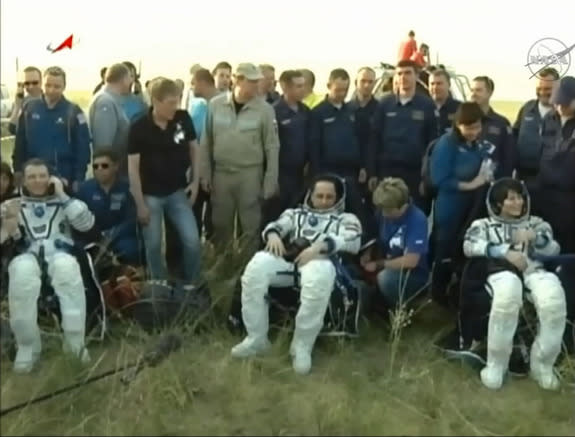 NASA astronaut Terry Virts (left), Russian cosmonaut Anton Shkaplerov (center) and European Space Agency Samantha Cristoforetti are seen just after exiting their Soyuz capsule following a smooth landing on June 11, 2015 on the steppes of Kazakh