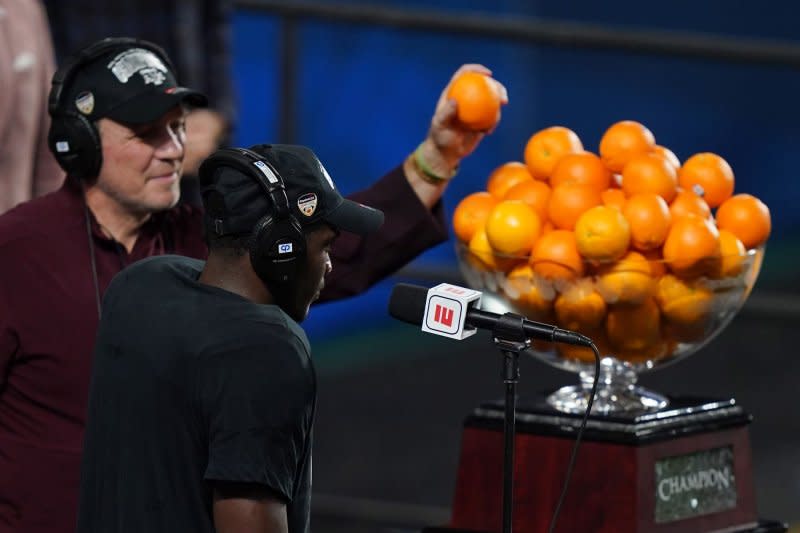 Texas A&M Aggies head coach Jimbo Fisher (L) and running back Devon Achane participate in the Orange Bowl trophy celebration after defeating the North Carolina Tar Heels 41-27 in the Orange Bowl at Hard Rock Stadium in Miami, Saturday, January 2, 2021. Photo by Hans Deryk/UPI