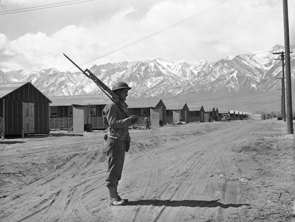 An American soldier guards a Japanese internment camp at Manzanar, Calif., May 23, 1943. (AP Photo)