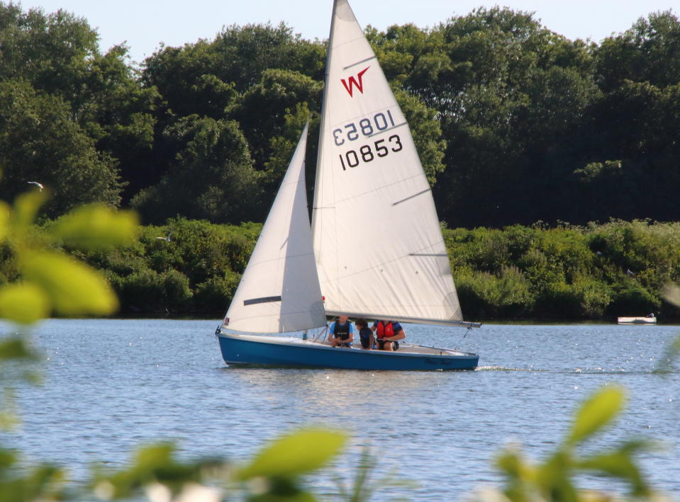 Men sailing on a dinghy at Priory Country Park Lake following the ease of restrictions on forms of exercise during the COVID 19 Lockdown as temperatures hit 27 degrees C, the hottest day of the year in the UK. (Photo by Keith Mayhew / SOPA Images/Sipa USA)