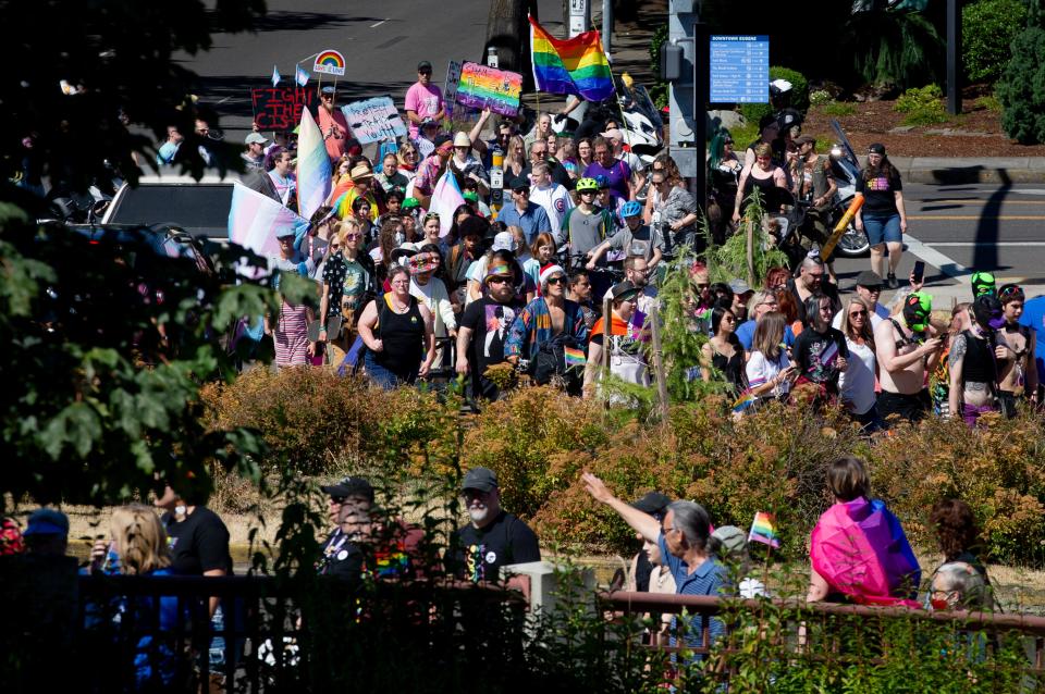 Marchers begin to ascend the Ferry Street Bridge Saturday, Aug. 13, 2022, in Eugene, Ore. en route to Eugene’s Pride in the Park at Alton Baker Park.