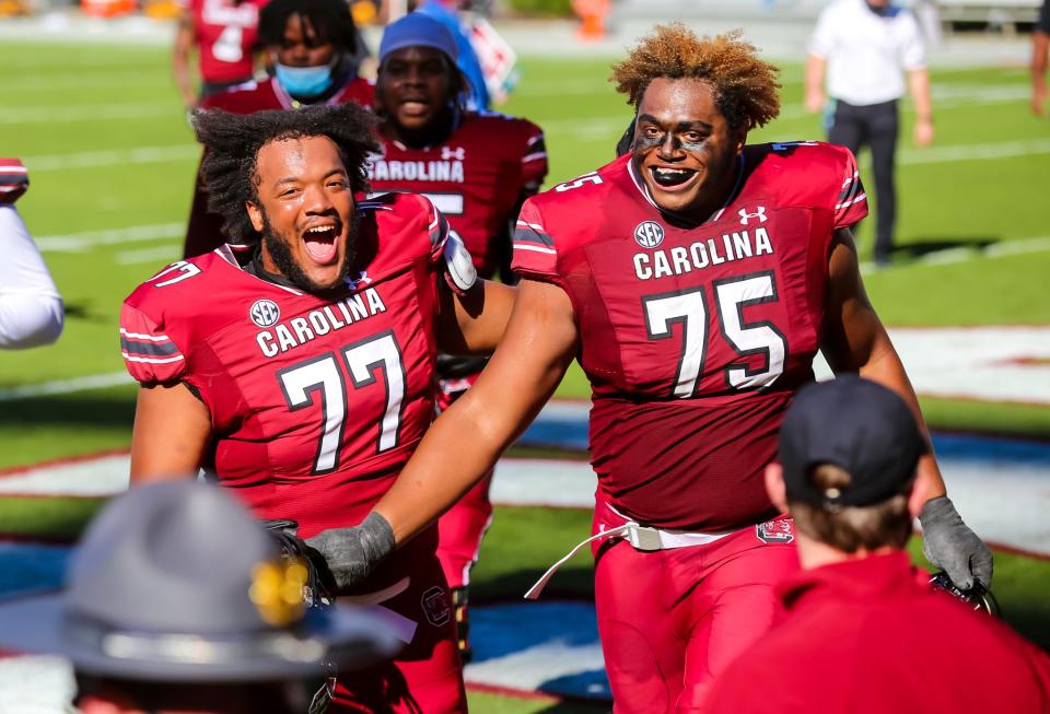 Oct 17, 2020; Columbia, South Carolina, USA; South Carolina Gamecocks offensive lineman Vershon Lee (77) and South Carolina Gamecocks offensive lineman Jazston Turnetine (75) celebrate following their win over the Auburn Tigers at Williams-Brice Stadium. Mandatory Credit: Jeff Blake-USA TODAY Sports