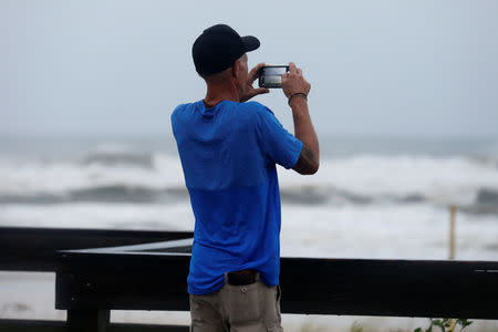 Local resident Marc Mills photographs a beach as Hurricane Michael approaches Panama City Beach, Florida, U.S. October 10, 2018. REUTERS/Jonathan Bachman