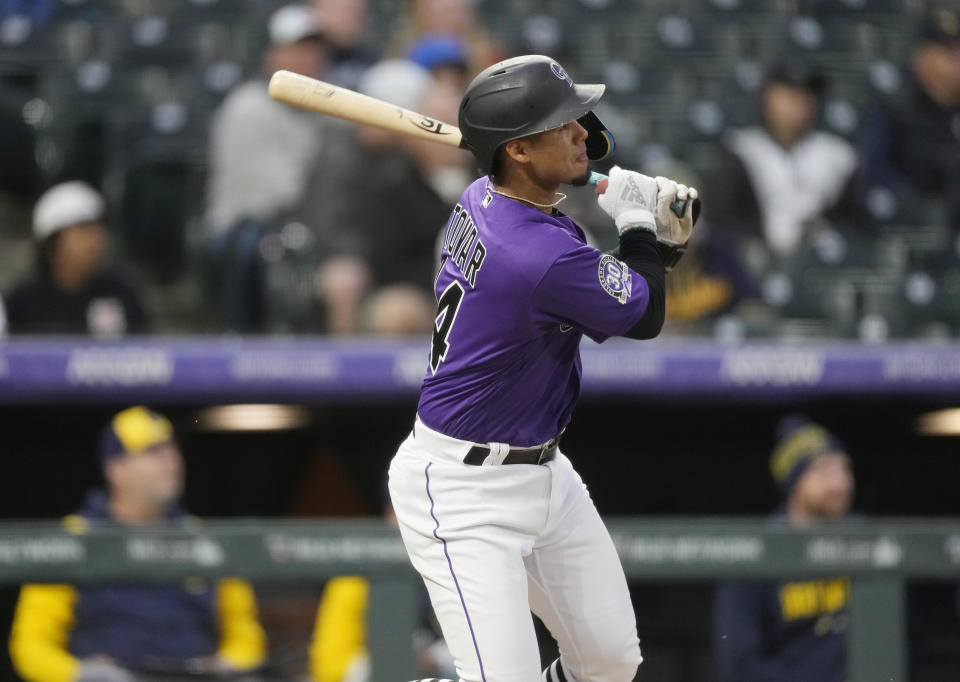 Colorado Rockies' Ezequiel Tovar follows the flight of his solo home run off Milwaukee Brewers starting pitcher Freddy Peralta in the third inning of a baseball game Tuesday, May 2, 2023, in Denver. (AP Photo/David Zalubowski)