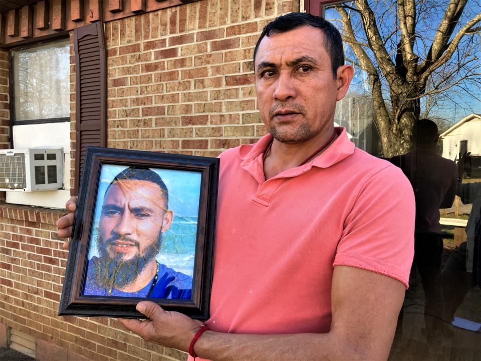Adan Cruz of Murfreesboro poses with photo of his killed brother Jose Reanos-Mendoza, who died in an inmate fight July 2021 while serving 30-day sentence at the Rutherford County Adult Detention Center.