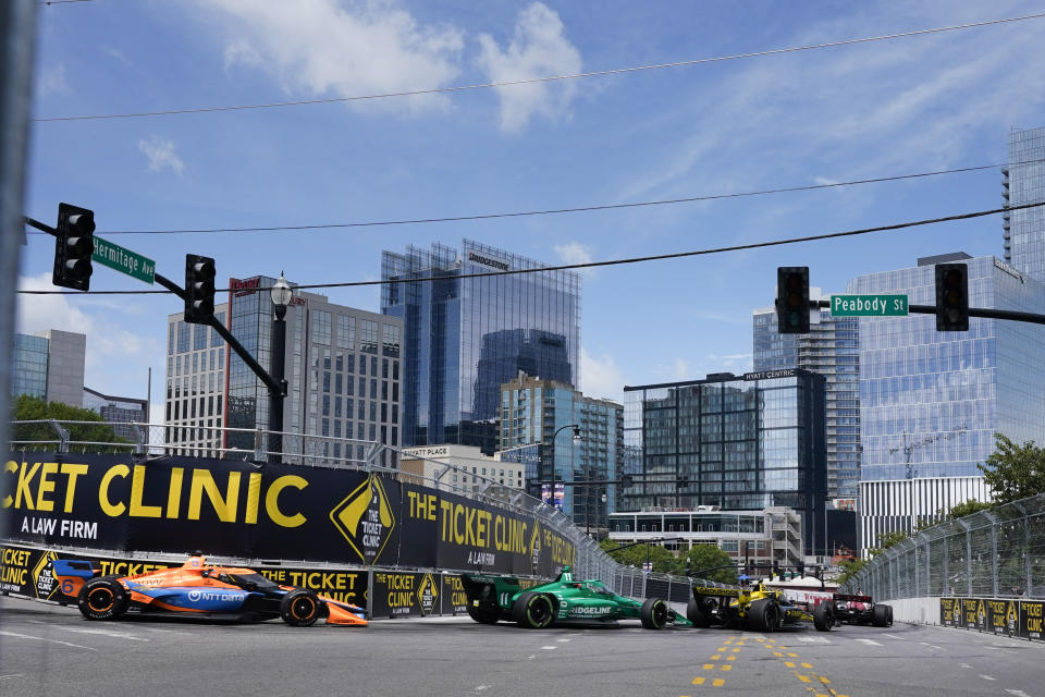 IndyCar drivers driver Felix Rosenqvist (6) and Marcus Armstrong (11) make their way through Turn 7 during the Music City Grand Prix auto race Sunday, Aug. 6, 2023, in Nashville, Tenn. (AP Photo/George Walker IV)
