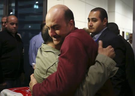 A passenger of EgyptAir flight 181 which was hijacked, embraces family members after arriving at Cairo international airport in Cairo, Egypt March 29, 2016. REUTERS/Mohamed Abd El Ghany