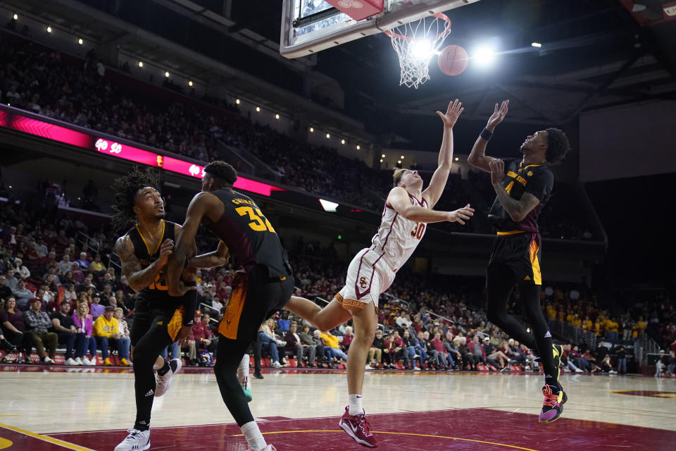 Southern California forward Harrison Hornery, second from right, scores between Arizona State forward Alonzo Gaffney (32) and guard Desmond Cambridge Jr., right, during the second half of an NCAA college basketball game Saturday, March 4, 2023, in Los Angeles. (AP Photo/Marcio Jose Sanchez)