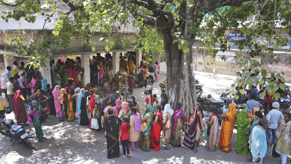 People stand in queue to register outside district hospital in Ballia, Uttar Pradesh state, India, Monday, June 19, 2023. Several people have died in two of India's most populous states in recent days amid a searing heat wave, as hospitals find themselves overwhelmed with patients. More than hundred people in the Uttar Pradesh state, and dozens in neighboring Bihar state have died due to heat-related illness. (AP Photo/Rajesh Kumar Singh)