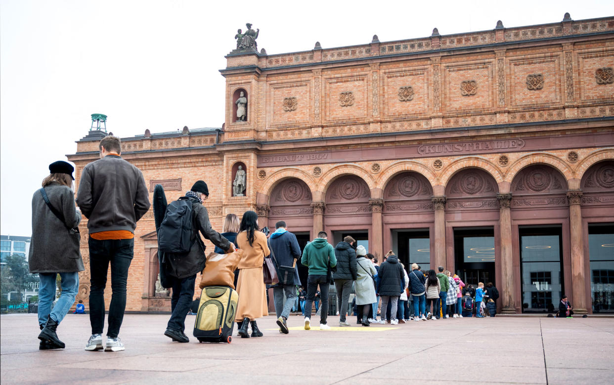 Visitors stand in line in front of the Kunsthalle, in Hamburg, Germany, on Oct. 31, 2022.