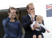 Britain's Prince William carries Prince George with his wife Kate, the Duchess of Cambridge as they depart for Sydney, Australia, from Wellington, New Zealand, Wednesday, April 16, 2014. (AP Photo/SNPA, Ross Setford) NEW ZEALAND OUT