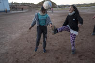 Students play soccer in Huancar, Jujuy Province, Argentina, Tuesday, April 25, 2023. The Andean town is prospering because of the work available in nearby lithium mines. (AP Photo/Rodrigo Abd)