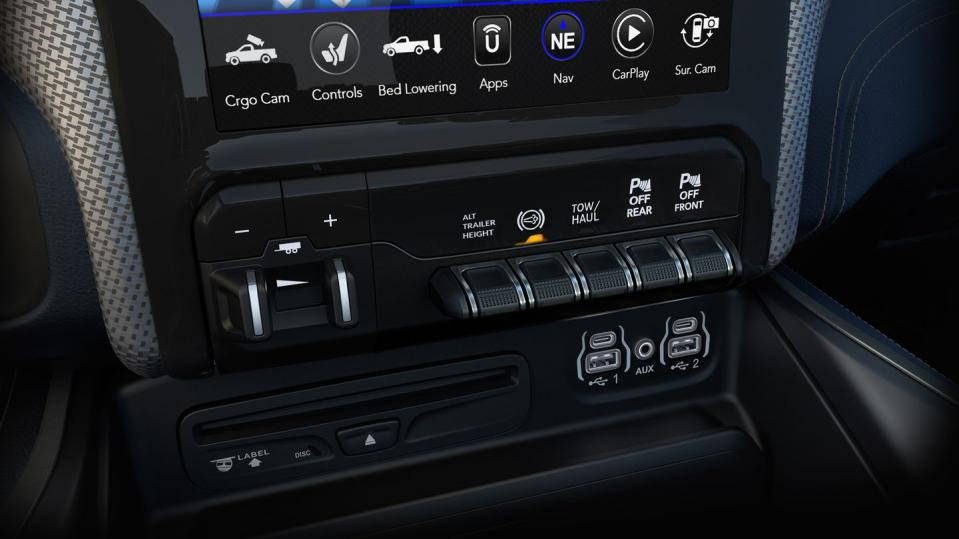<p>The redesigned center console provides enough storage area to put a 15-inch laptop out of sight and offers three USB ports in front and two in back for a total of five; three of them, including one in back, communicate with the Uconnect infotainment system.</p>