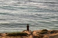 <p>An ultra-Orthodox Jewish man prays along the Mediterranean Sea in the Israeli city of Herzliya, near Tel Aviv, while performing the “Tashlich” ritual on Sept. 28, 2017, during which “sins are cast into the water to the fish”. The “Tashlich” ritual is performed before the Day of Atonement, or Yom Kippur, the most important day in the Jewish calendar, which in 2017 starts at sunset on Sept. 29. (Photo: Jack Guez/AFP/Getty Images) </p>