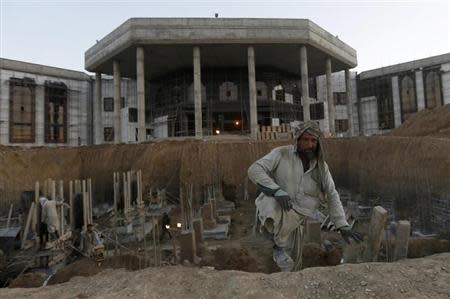 Afghans work at a new parliament building constructed by an Indian project in Kabul November 26, 2013. REUTERS/Mohammad Ismail/Files