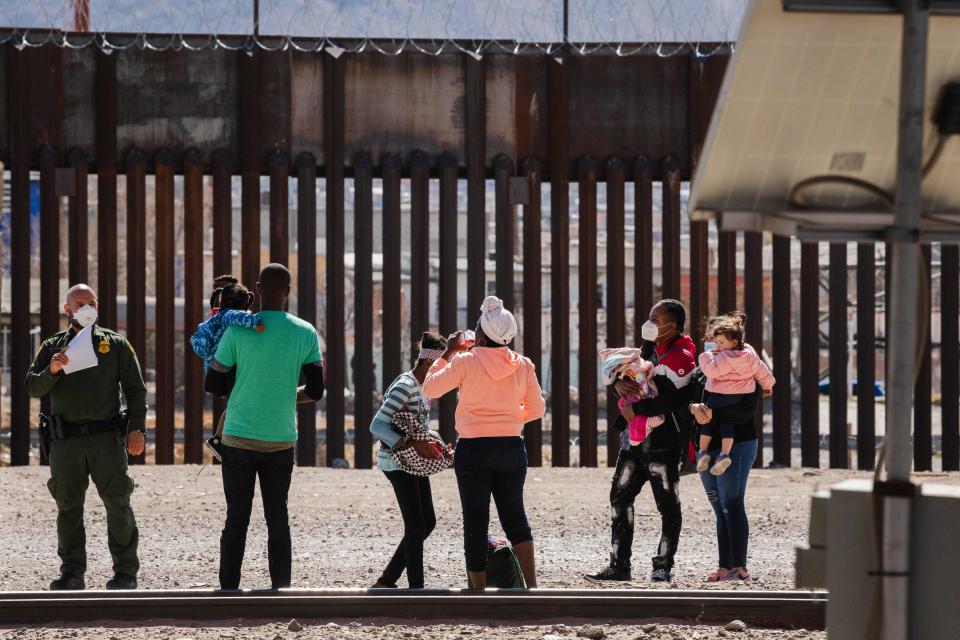 Border Patrol agents apprehend a group of migrants near downtown El Paso, Texas, following the congressional border delegation visit on March 15, 2021.