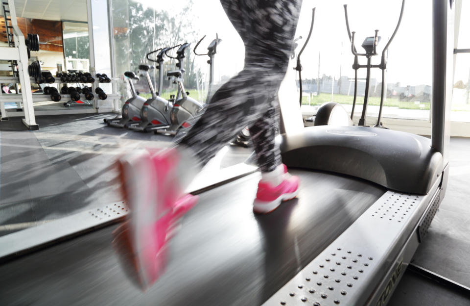 A woman running on a treadmill.