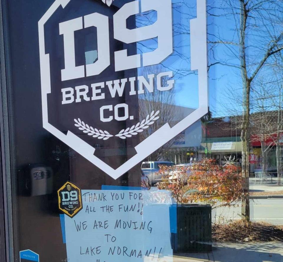 A sign on D9 Brewing on Main Street tells customer that the business has moved to Lake Norman.