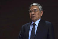 Bank of Japan Gov. Haruhiko Kuroda walks in the venue as he attends a news conference in Tokyo Monday, March 16, 2020. Japan's central bank took emergency action Monday to help support the economy following the U.S. Federal Reserve's decision to cut its benchmark interest rate to nearly 0%. (AP Photo/Eugene Hoshiko)