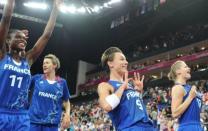 French captain Celine Dumerc (C) and teammate Florence Lepron (R) celebrate after defeating Russia in the women's basketball semi-final at the London Olympics on August 9. "We're very proud to face the USA," French captain Celine Dumerc said