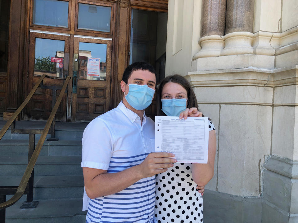 The bride and groom with their marriage license. (Courtesy of Erin Farley)
