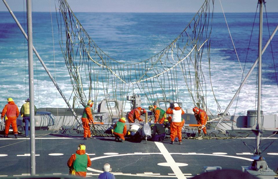 The Navy operating drones from ships other than aircraft carriers is not altogether new. Here, crewmen disengage a Pioneer I drone from a recovery net erected on the stern of the battleship USS <em>Iowa</em> (BB-61), back in 1986. <em>U.S. Navy</em>