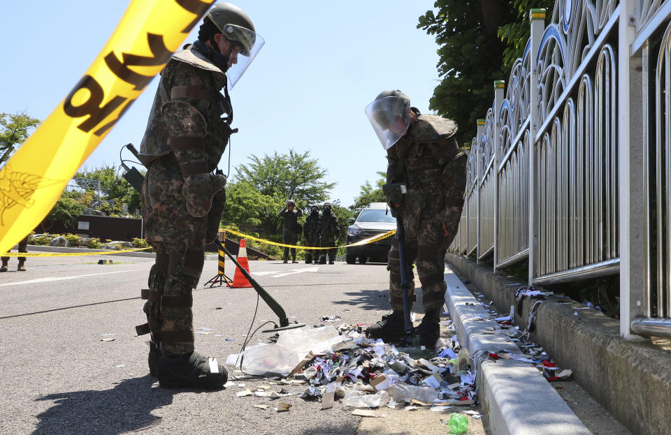 South Korean soldiers wearing protective gears check the trash from a balloon presumably sent by North Korea, in Incheon, South Korea, Sunday, June 2, 2024. North Korea launched hundreds of more trash-carrying balloons toward the South after a similar campaign a few days earlier, according to South Korea’s military, in what Pyongyang calls retaliation for activists flying anti-North Korean leaflets across the border. (Im Sun-suk/Yonhap via AP)