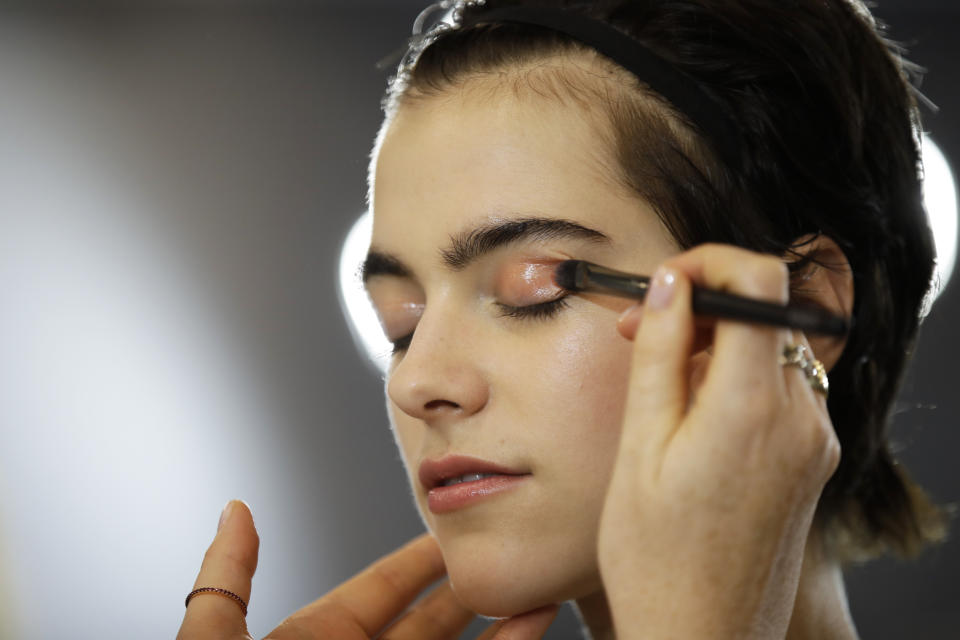 A model has make up applied backstage prior to the N. 21 Spring-Summer 2020 collection, unveiled during the fashion week, in Milan, Italy, Wednesday, Sept. 18, 2019. (AP Photo/Luca Bruno)