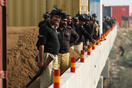 Police watch as supporters of Pakistani opposition leader Imran Khan shout slogans at a spot where police blocked the highway with shipping containers in Swabi, between Peshawar and Islamabad, Pakistan October 31, 2016. REUTERS/Fayaz Aziz