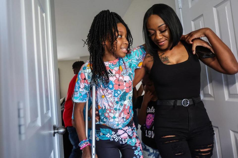 Stacy Fulmore, right, with Aalayah in the home in Charlotte they moved into after Stacy decided she couldn’t keep her family in the apartment where the shooting happened.