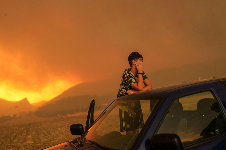 A wildfire approaches the Greek village of Avantas on Aug. 21, 2023. (Konstantinos Tsakalidis / Bloomberg via Getty Images file)