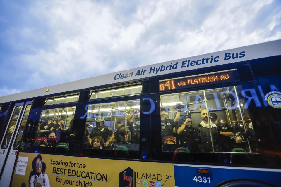 Police stand among protesters detained on a bus in Brooklyn on May 29. (Photo: AP Photo/Frank Franklin II)