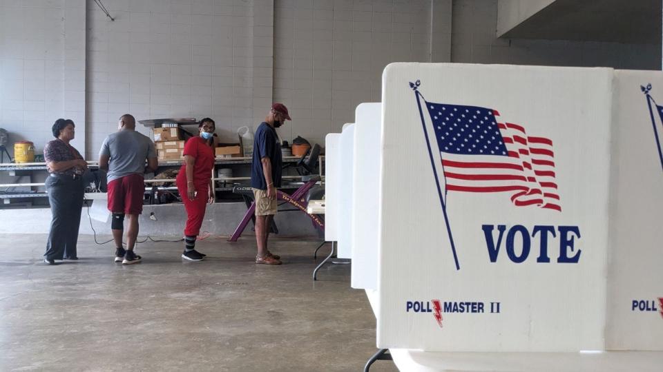 Voters stand in line to cast their ballots in the primary election as soon as the poll opened at Jackson Fire Station 26 in Jackson on Tuesday morning.