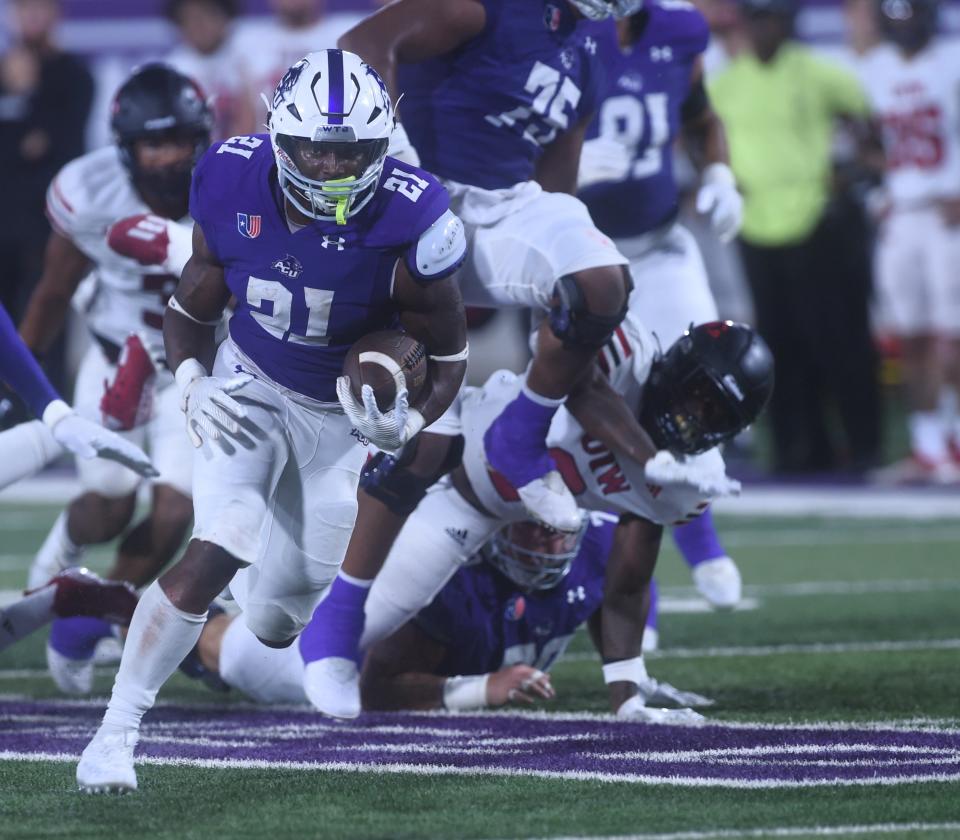 ACU running back Jermiah Dobbins (21) eyes the end zone while running through the Incarnate Word defense. Dobbins ran 29 yards for the game's first score with 4:16 left in the second quarter Sept. 16 at Wildcat Stadium in Abilene.