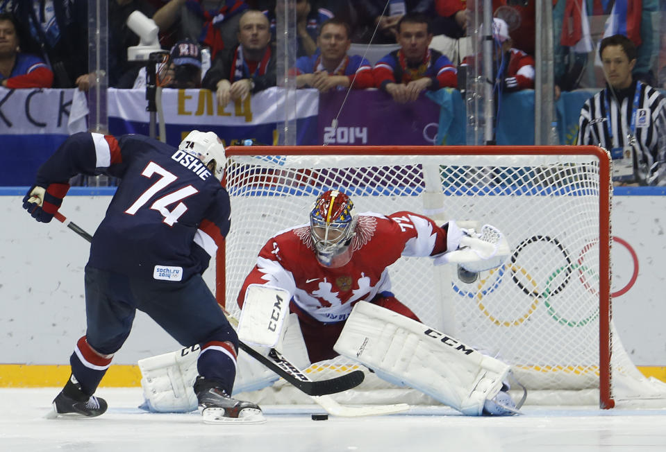 USA forward T.J. Oshie prepares to take a shot against Russia goaltender Sergei Bobrovsky during a shootout in a men's ice hockey game at the 2014 Winter Olympics, Saturday, Feb. 15, 2014, in Sochi, Russia. Oshie scored the winning goal and the USA won 3-2. (AP Photo/Mark Humphrey)