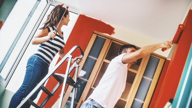 Closeup tilt shot of late 20's couple redecorating their apartment.