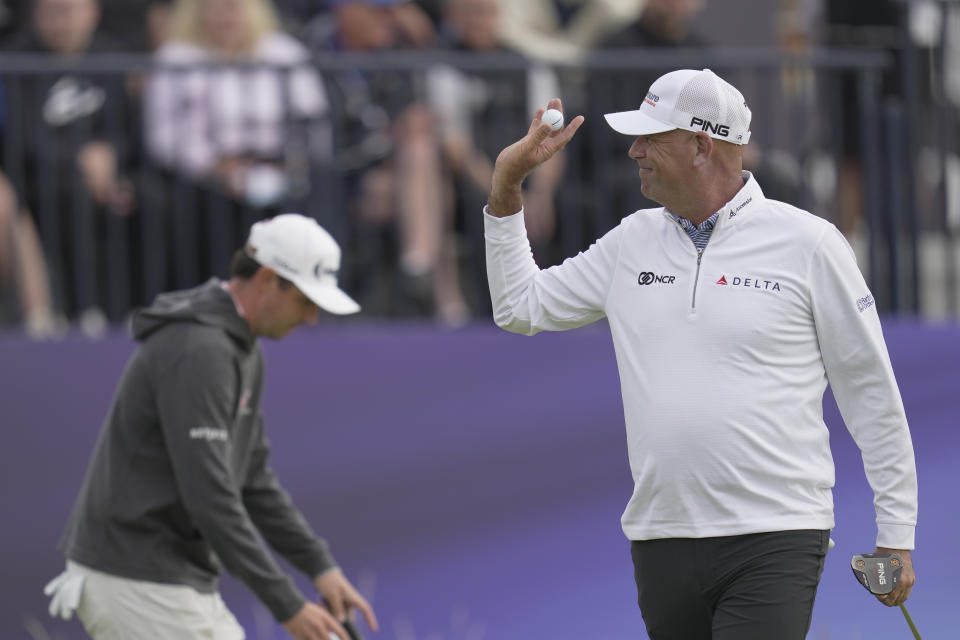 United States' Stewart Cink acknowledges the crowd on the 3rd green on the first day of the British Open Golf Championships at the Royal Liverpool Golf Club in Hoylake, England, Thursday, July 20, 2023. (AP Photo/Kin Cheung)