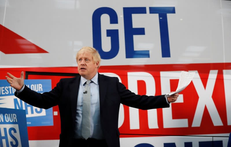 Britain's Prime Minister Boris Johnson addresses his supporters in front of the general election campaign trail bus in Manchester