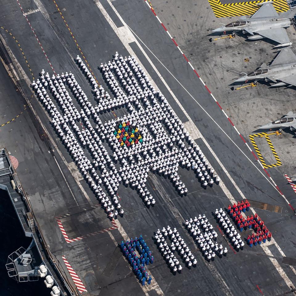 Sailors lined up in the shape of Notre Dame