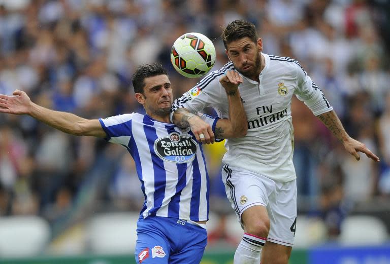 Real Madrid's Sergio Ramos (R) fights for the ball during a Spanish league match in La Coruna, on September 20, 2014