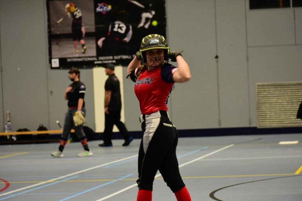 McKenna Morrill, a catcher for Belvidere North, flexes while she poses for a picture during The Cup indoor softball tournament in Schiedam, Netherlands, on Saturday, Jan. 14, 2023.