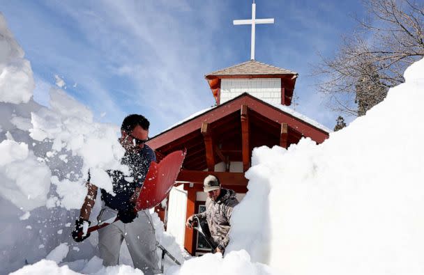 PHOTO: Residents shovel snow from in front of a church after a series of winter storms dropped more than 100 inches of snow in the San Bernardino Mountains in Southern California, March 8, 2023, in Twin Peaks, Calif. (Mario Tama/Getty Images)