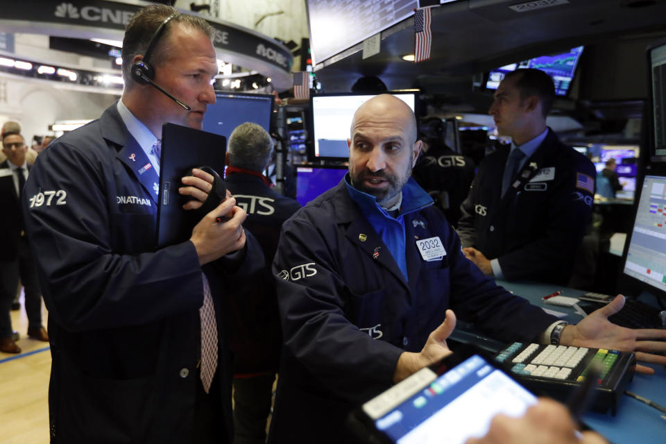 Trader Jonathan Corpina, left, and specialist James Denaro work on the floor of the New York Stock Exchange, Friday, Nov. 15, 2019. Stocks are opening broadly higher on Wall Street as hopes continued to grow that the U.S. and China were moving closer to a deal on trade. (AP Photo/Richard Drew)