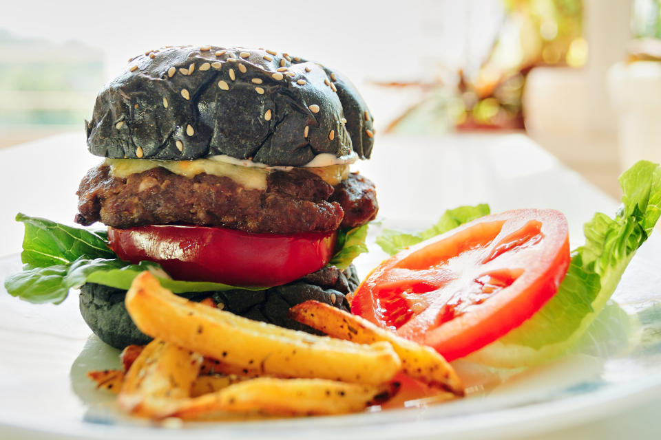 A burger on a charcoal bun