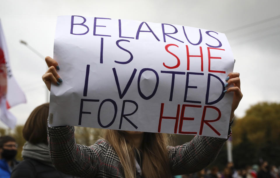 A woman holds a placard during an opposition rally to protest the official presidential election results in Minsk, Belarus, Sunday, Oct. 25, 2020. The demonstrations were triggered by official results giving President Alexander Lukashenko 80% of the vote in the Aug. 9 election that the opposition insists was rigged. Lukashenko, who has ruled Belarus with an iron fist since 1994, has accused the United States and its allies of fomenting unrest in the ex-Soviet country. (AP Photo)