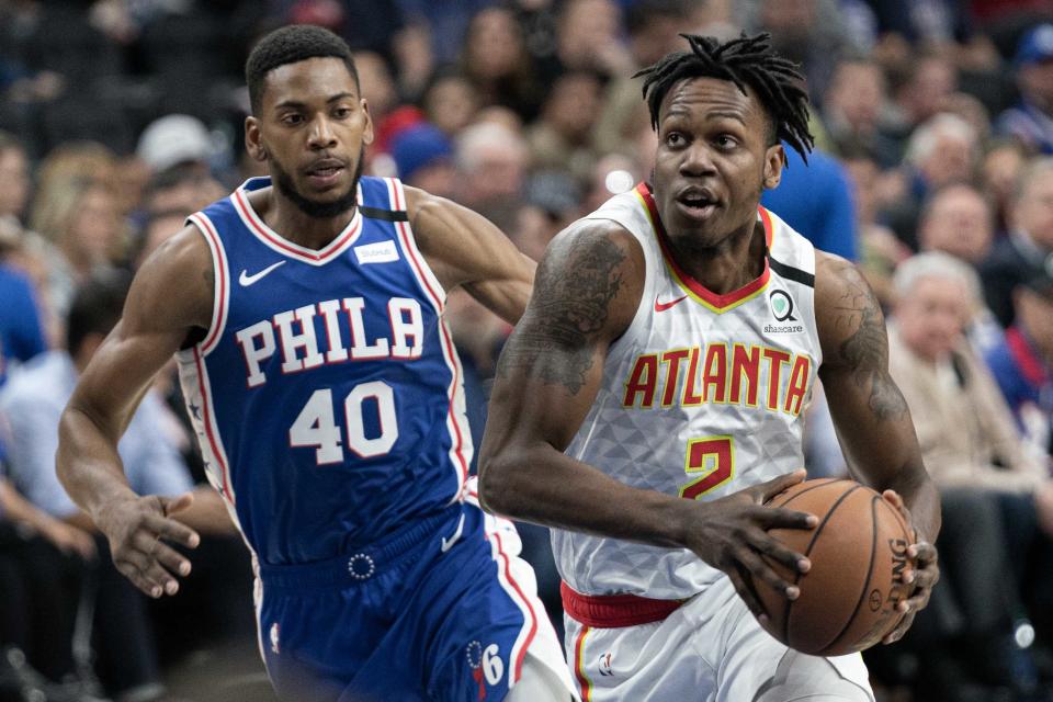 Feb 24, 2020; Philadelphia, Pennsylvania, USA; Atlanta Hawks guard Treveon Graham (2) drives against Philadelphia 76ers forward Glenn Robinson III (40) during the first quarter at Wells Fargo Center. 