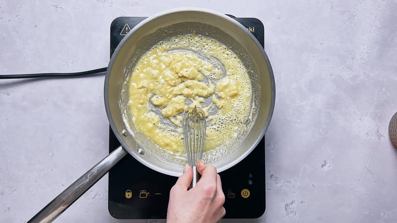 whisking a roux in skillet